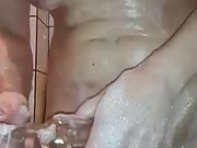 Sexy milf is masturbating her shaved pussy in the bathtub