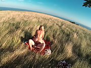 Daring sex in a field near to the sea on a summers day